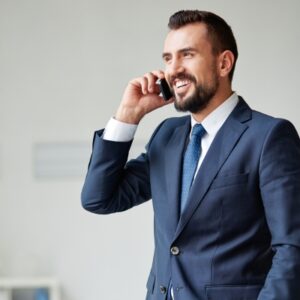 Man in business suit talks on the phone